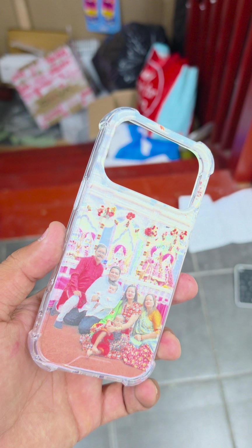 Finished clear phone case featuring a family photograph, held up at Fonebook
