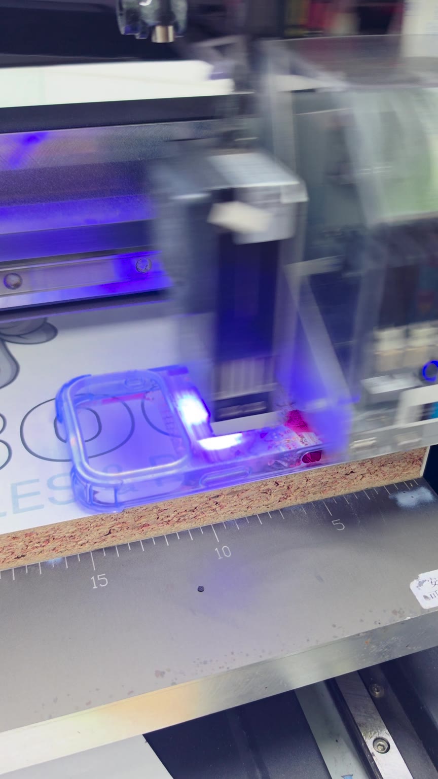 UV printer working on a personalised clear phone case at Fonebook in Horden