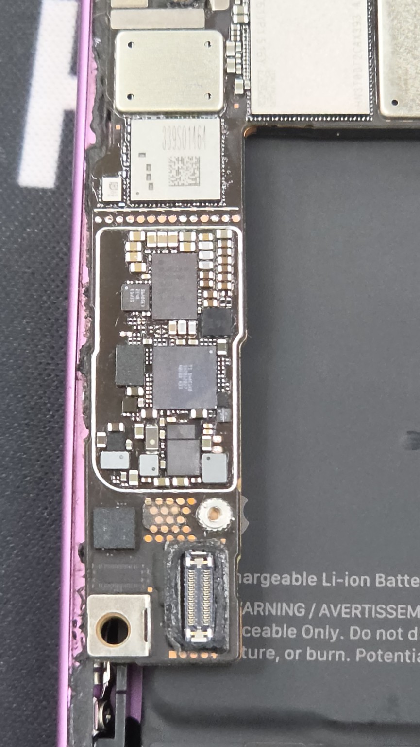 Close-up of exposed components on the iPhone 16 motherboard during the Fonebook charging repair