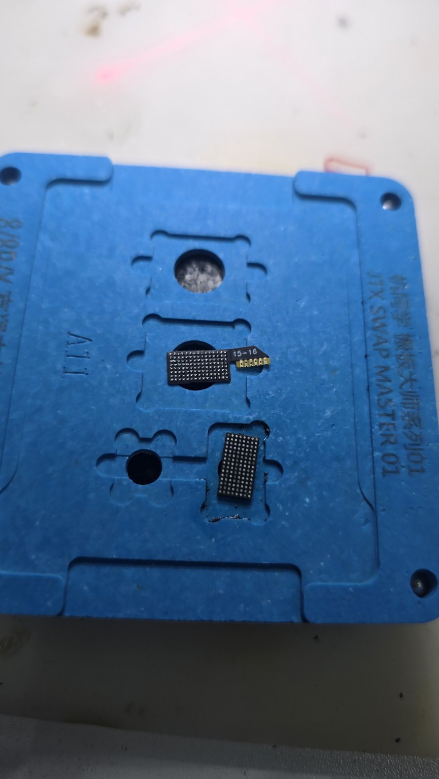 Close-up of display chip solder contacts on the repair fixture at Fonebook