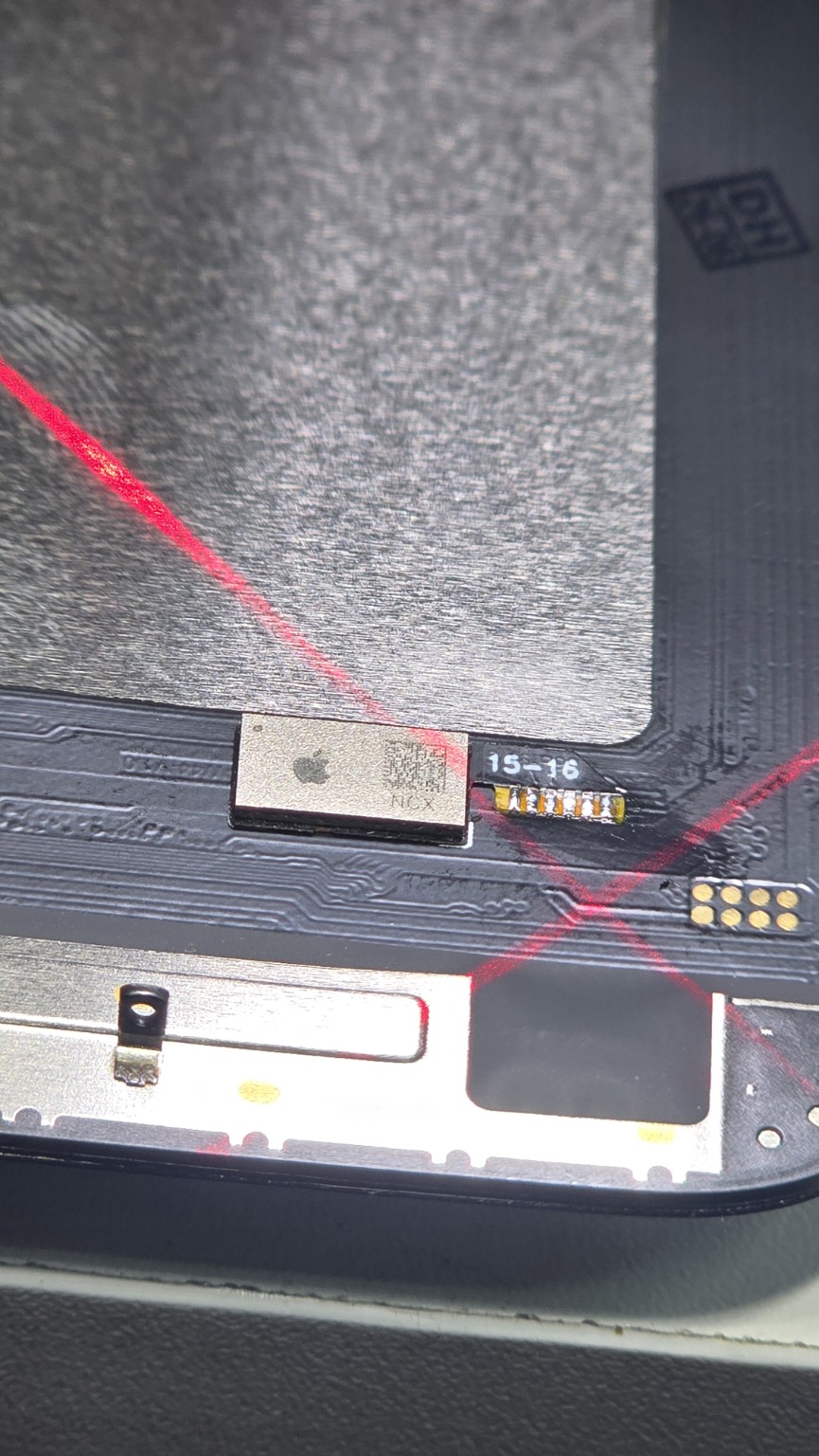 Close-up of the display chip positioned on the screen flex during iPhone 16 Plus repair