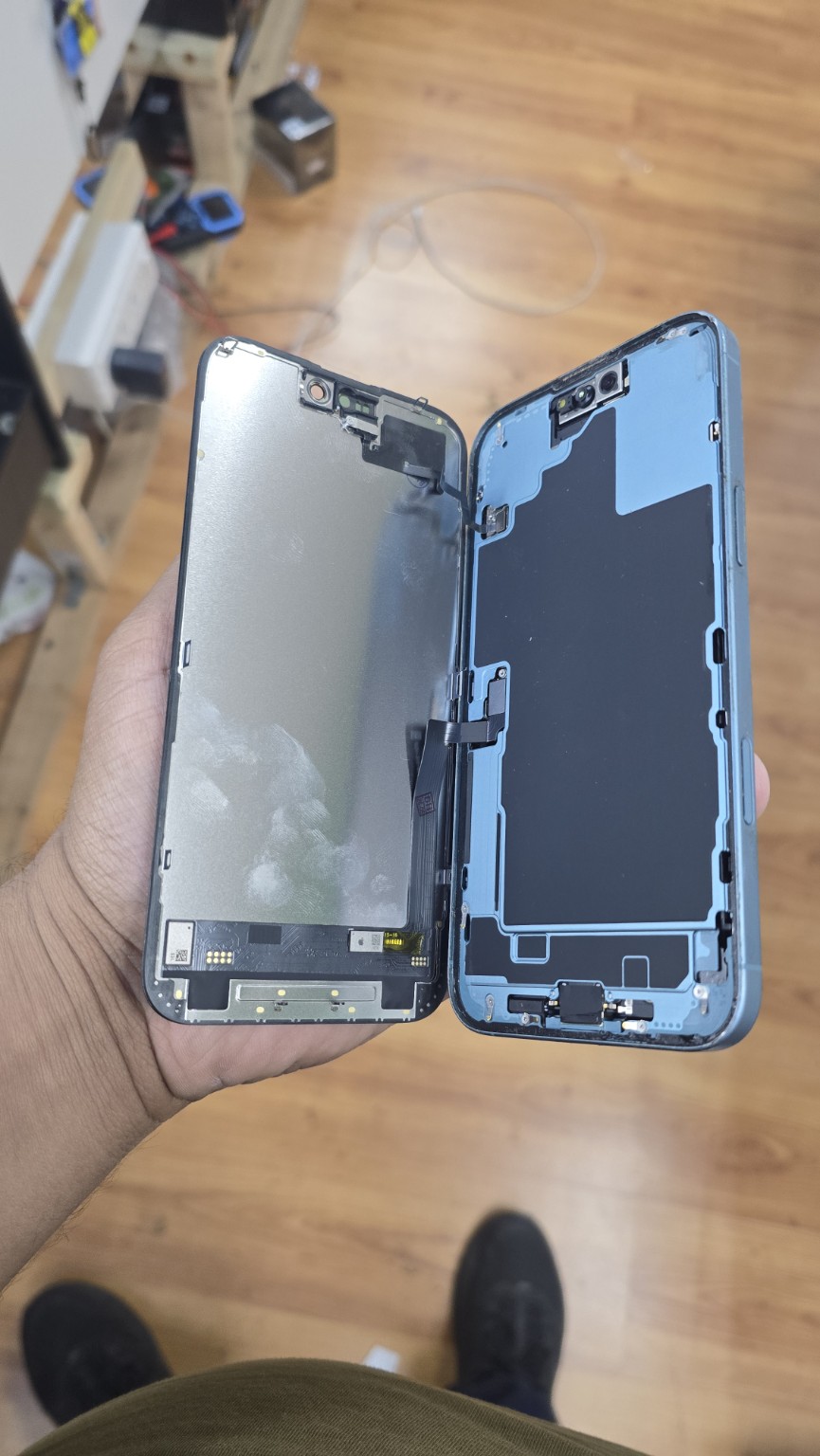 Opened iPhone 16 Plus with the display assembly connected during repair at Fonebook